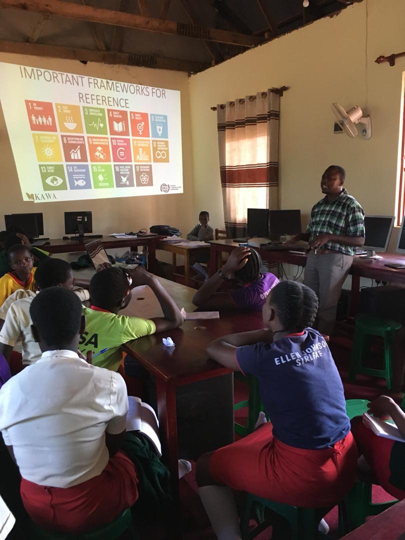 Nicholas-Kugonza-sharing-information-about-SDGs-with-ICT-Club-members-of-St.-Elizabeth-Secondary-School-Mityana